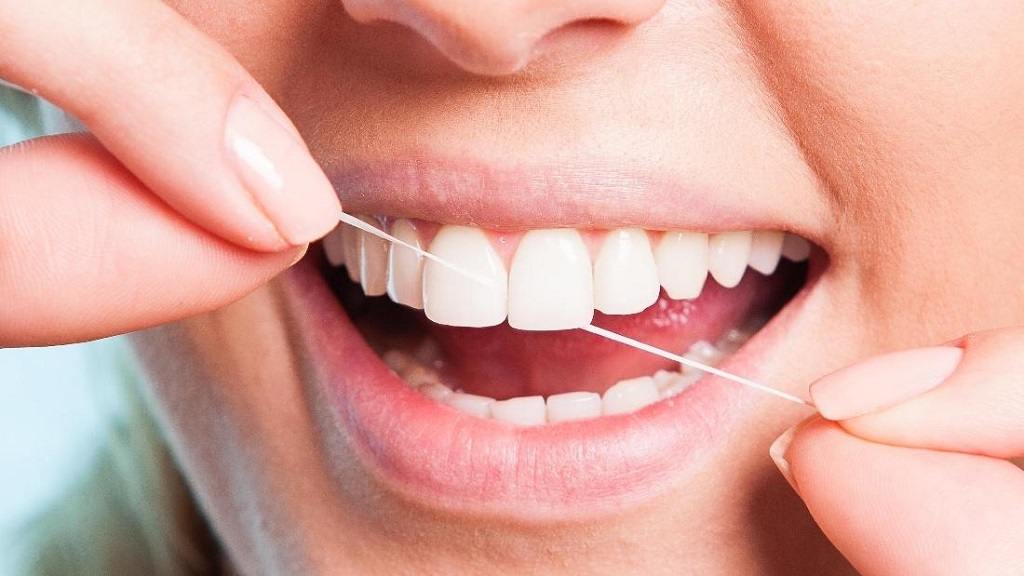 Floss Daily  to Prevent Cavities and Gum Disease